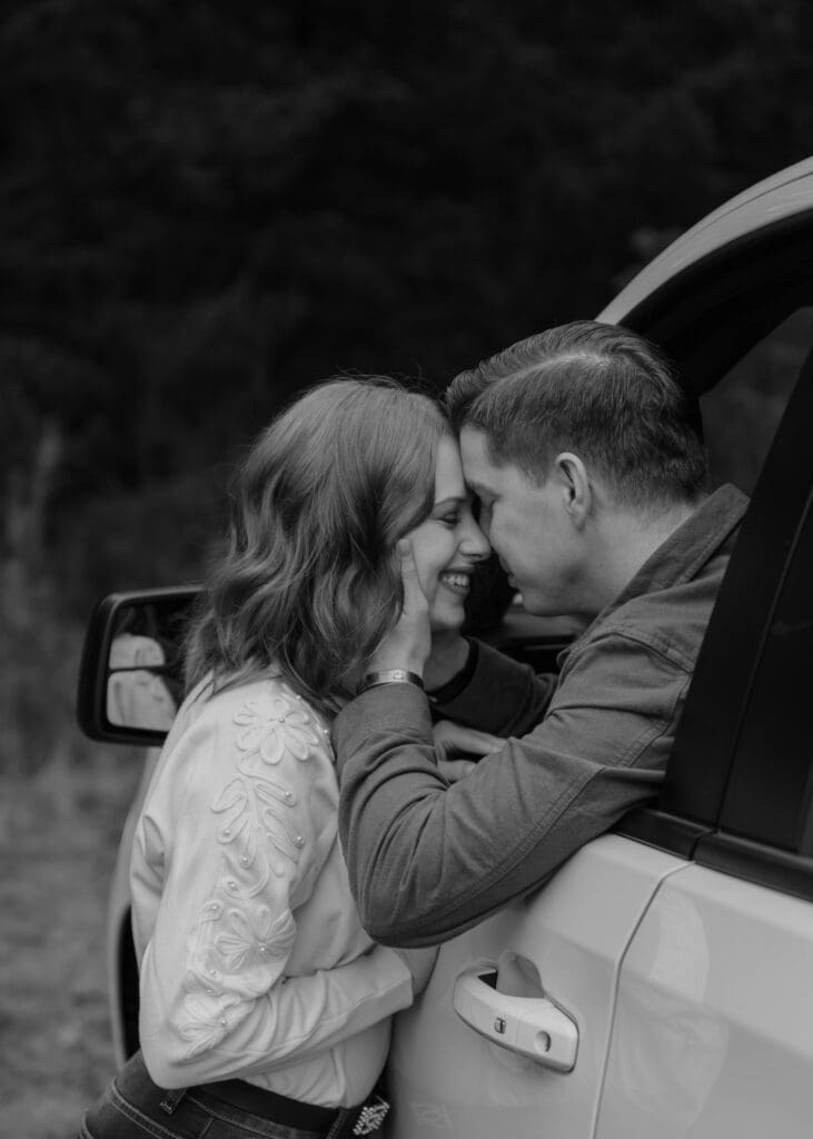 black and white couple with thier foreheads together 