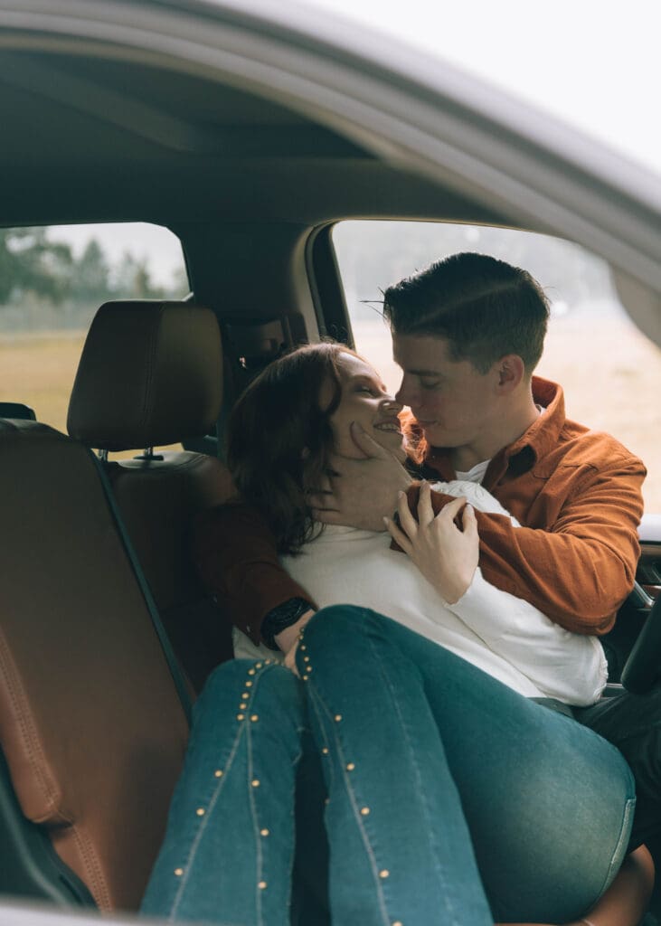 husband and wife lean in for a kiss