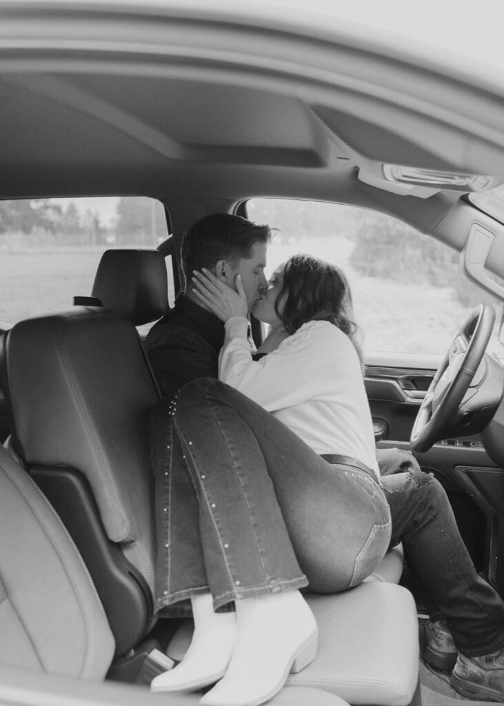 black and white couple kissing in a truck 