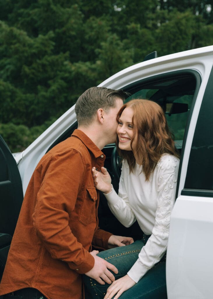 couple laughing in a truck 