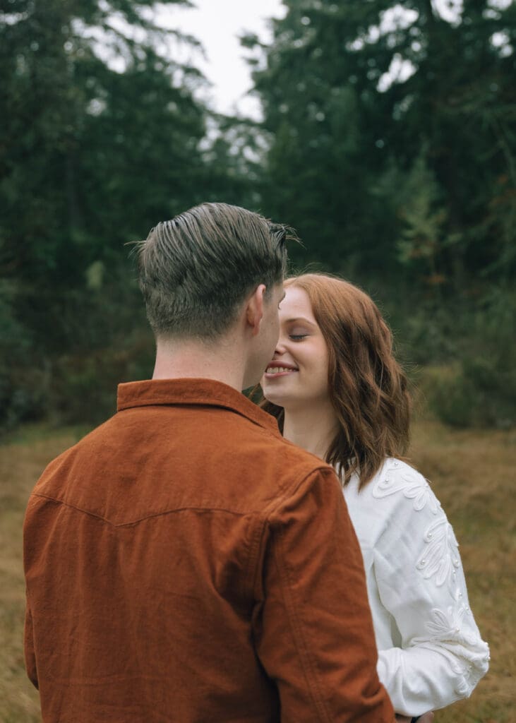 couple giving eskimo kisses outside at Joint Base Lewis McChord