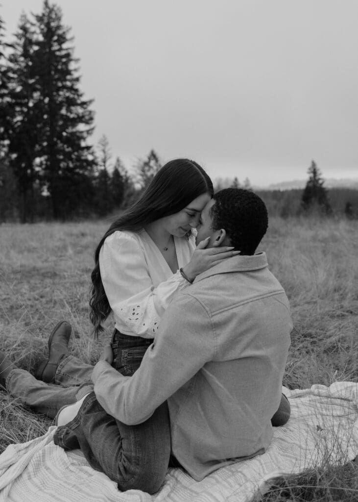 black and white photo of a couple touching foreheads