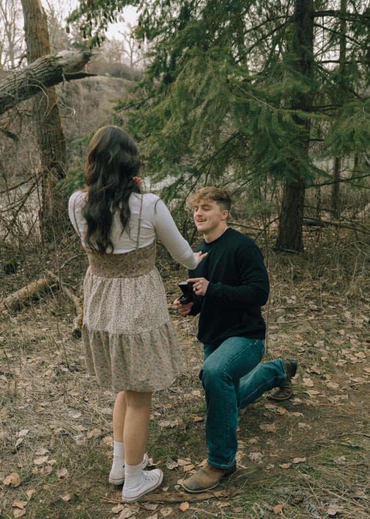 man proposing to his girlfriend in the woods