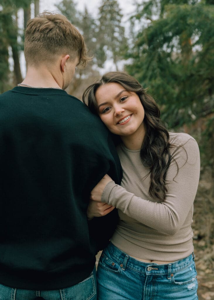 girl leaning on boyfriends shoulder during engagement session