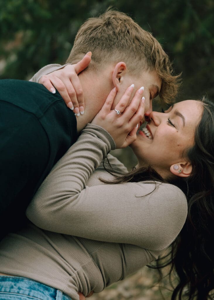couple laughing and almost kissing during engagement session 