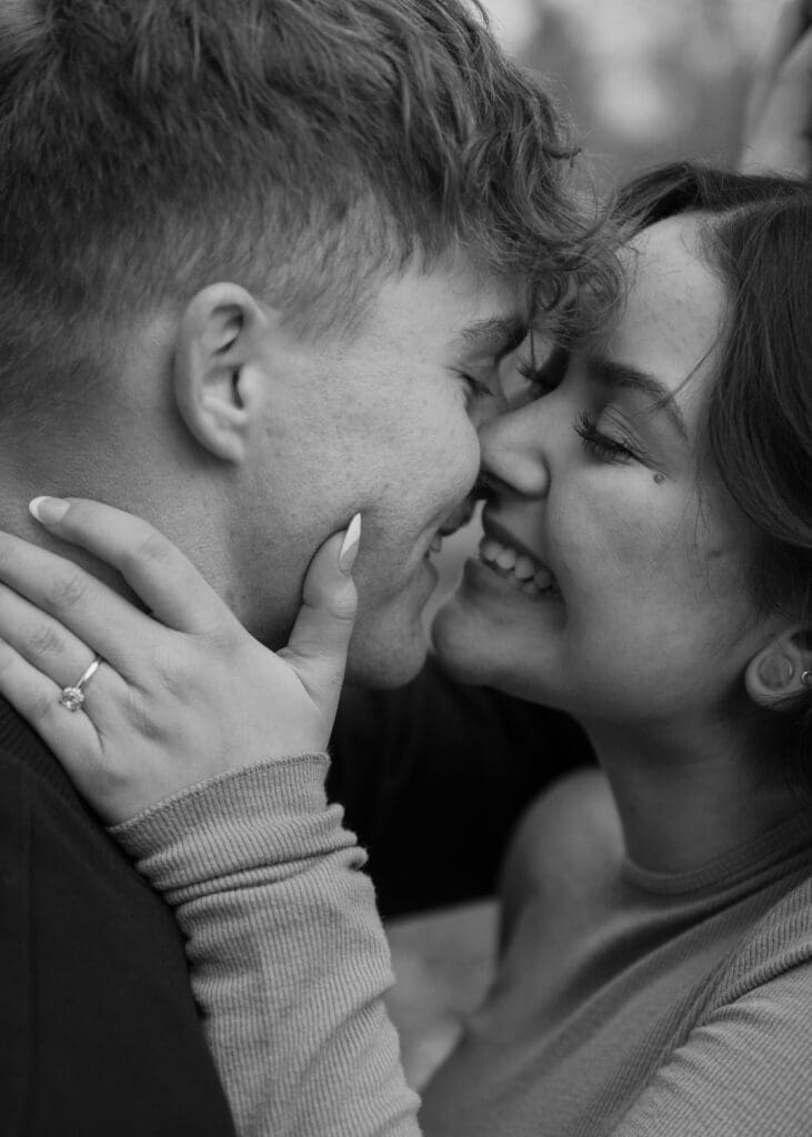 black and white close up of couple almost kissing 