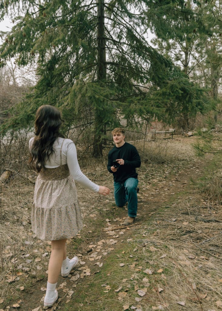 man down on one knee to propose