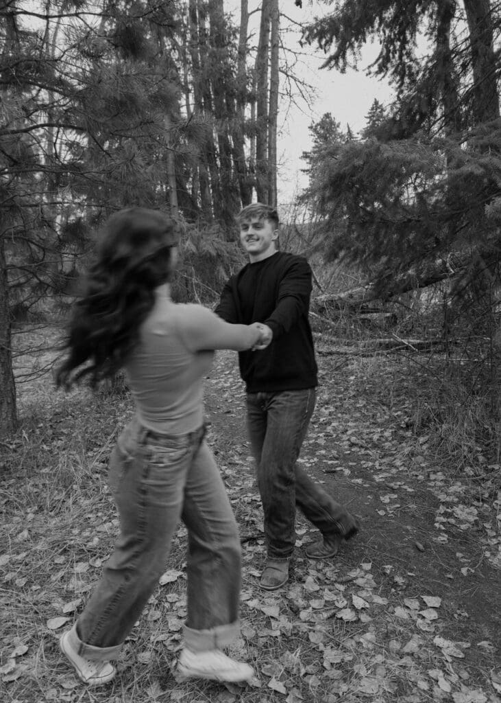 black and white photo of couple swinging around