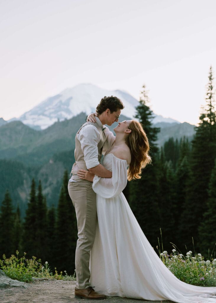 bride and groom almost kissing romantically at blue hour in front of Mt. Rainier