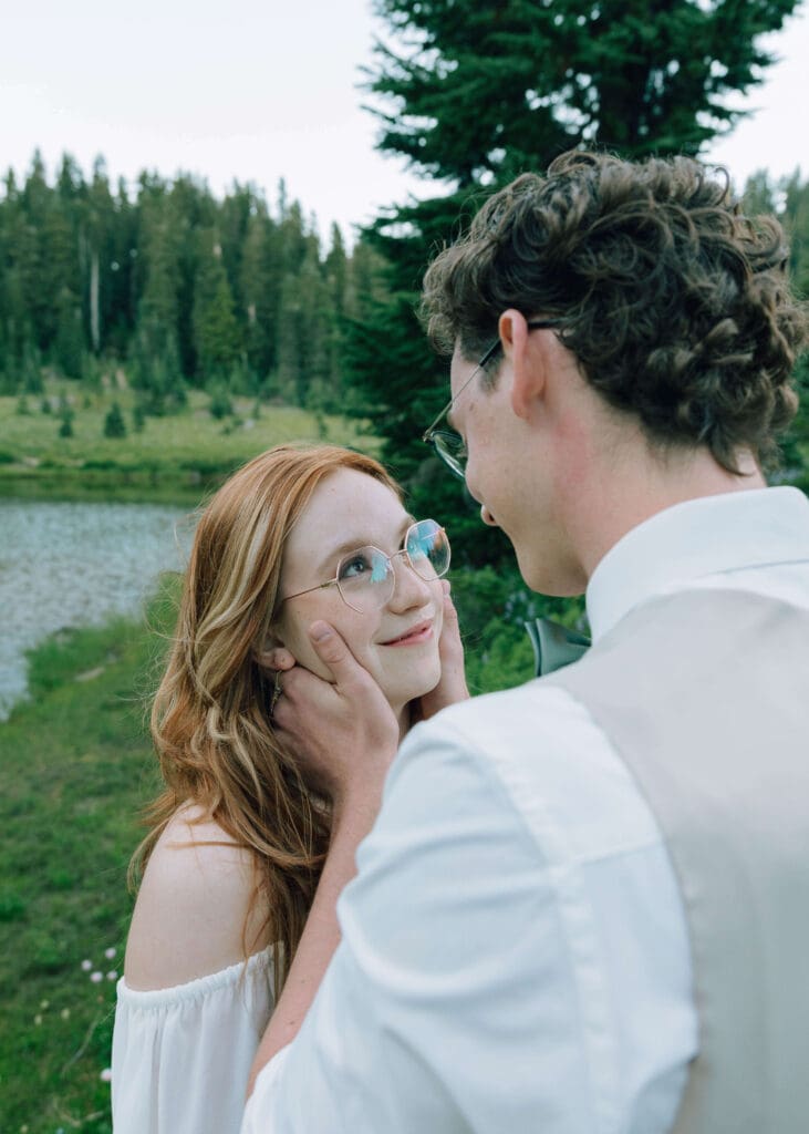 groom holding his bride's face at Lake Tipsoo 