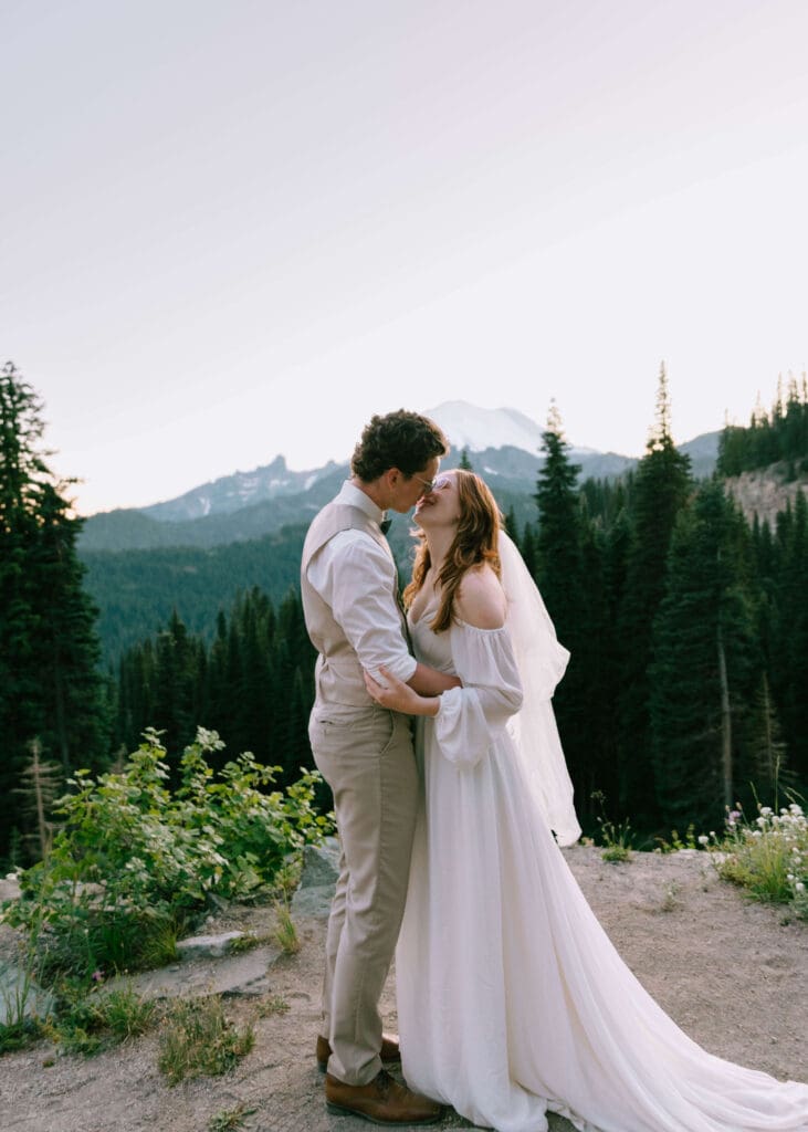 bride and groom almost kissing in front of mt rainier in the summer at sunset 