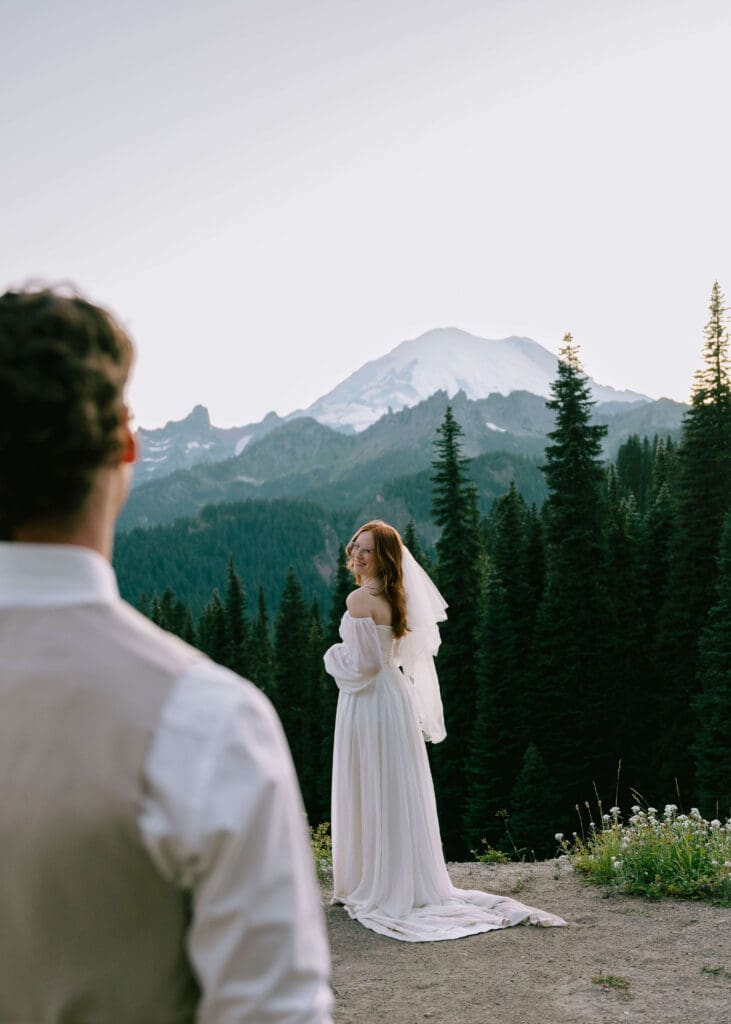 groom admiring bride in front of mt rainier at summer elopement 