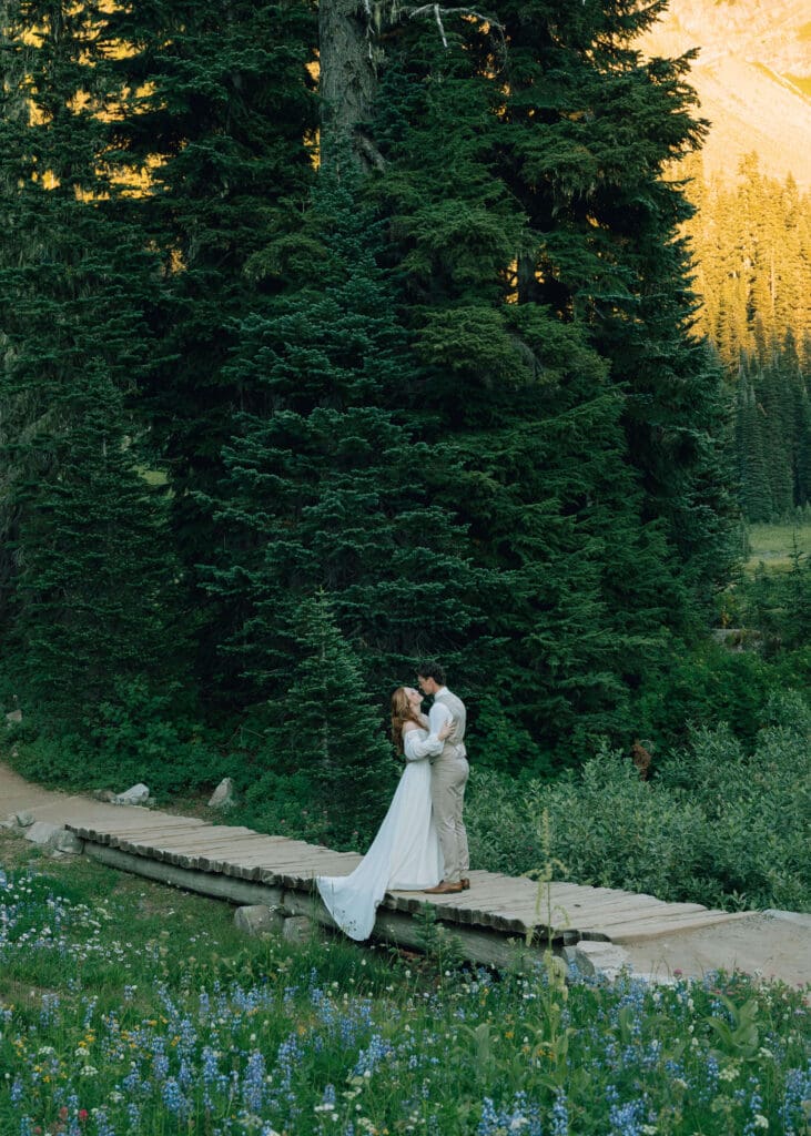 couple almost kissing on a bridge at Mt Rainier national park elopement