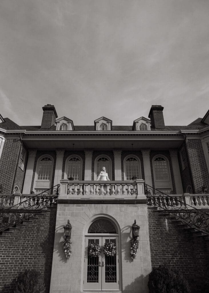 bride looking out at James river standing on the terrace at Virginia wedding venue 
