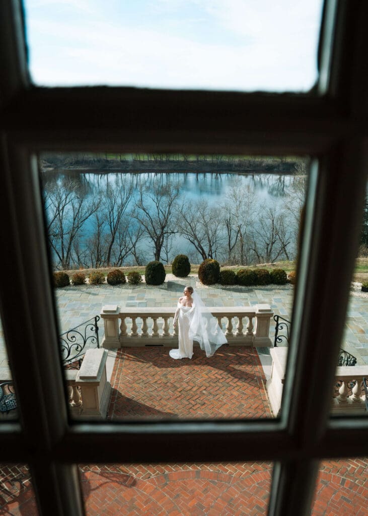 bride standing outside on terrace at estate at river run 