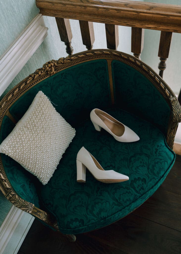bridal shoes on green vintage chair at mansion wedding venue in Virginia