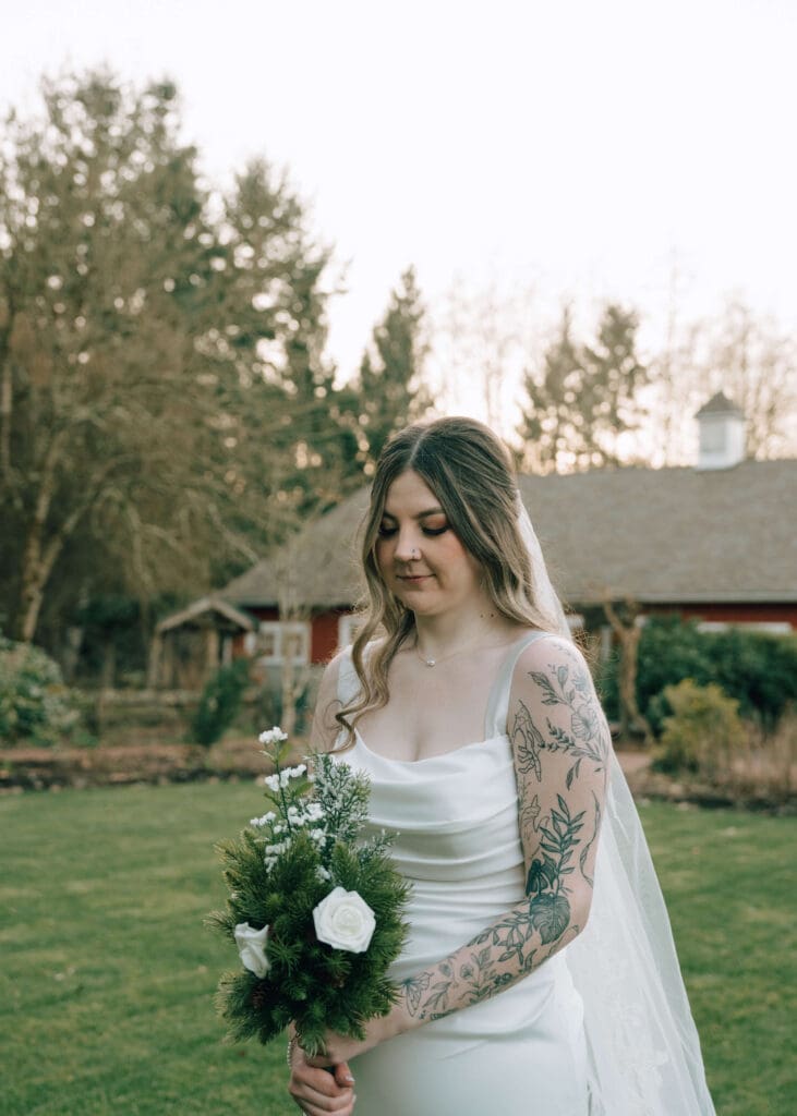 bride looking down at her bouquet during golden hour at Issaquah wedding venue 