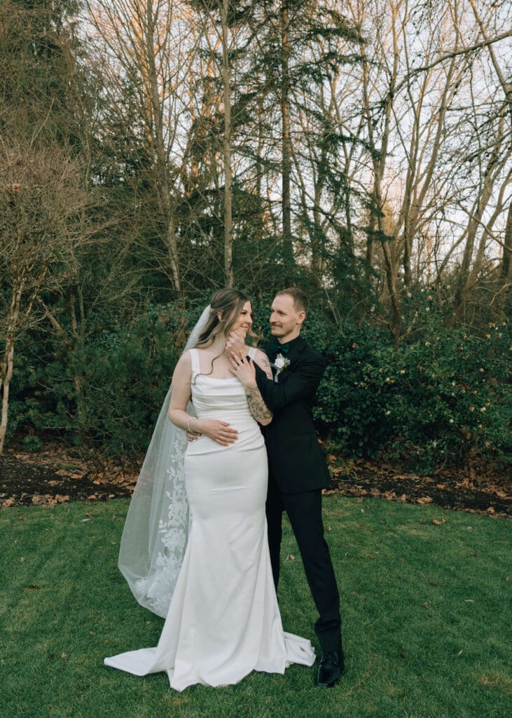 groom holding bride's face outside at golden hour at Issaquah barn wedding 