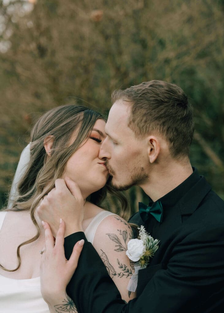 bride and groom kissing during sunset at winter outdoor wedding at Issaquah wedding venue