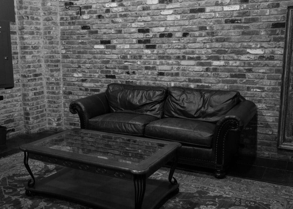 bridal getting ready space with couch and brick wall at Historic 1625