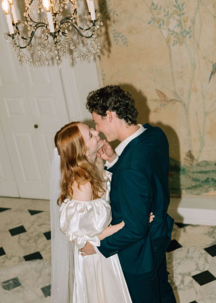 bridal couple almost kissing while groom holds brides face inside lakewold gardens in Tacoma
