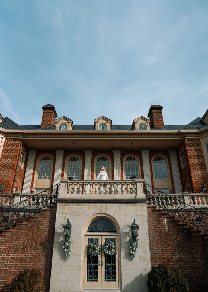 bride standing on terrace looking out over balcony 