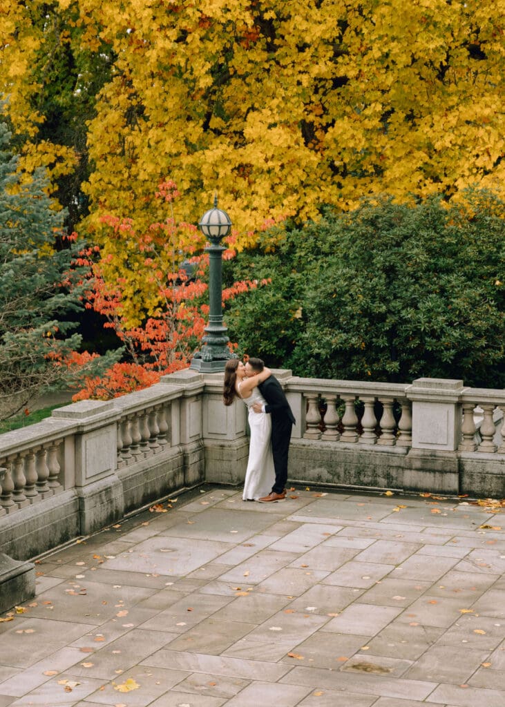 couple kissing in courtyard for washington state capitol engagement 