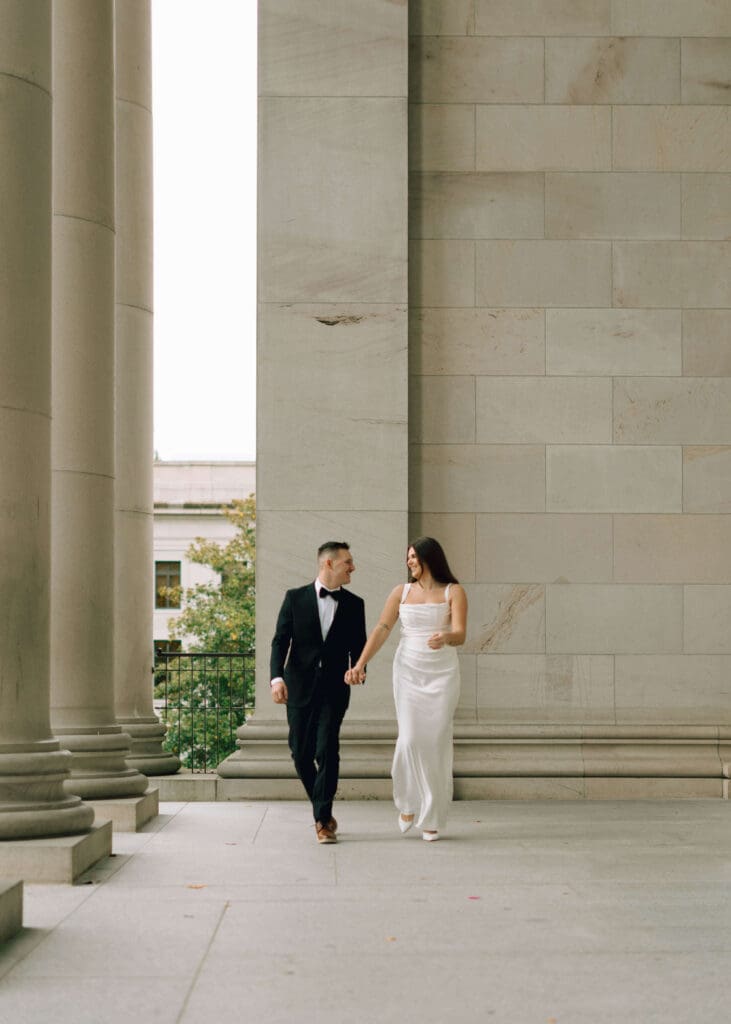 couple walking hand in hand dressed nicely in Olympia 