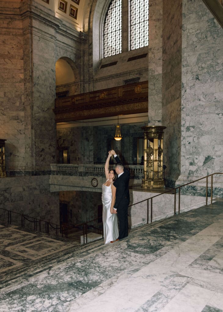 groom spinning his bride around at Washington state capitol 