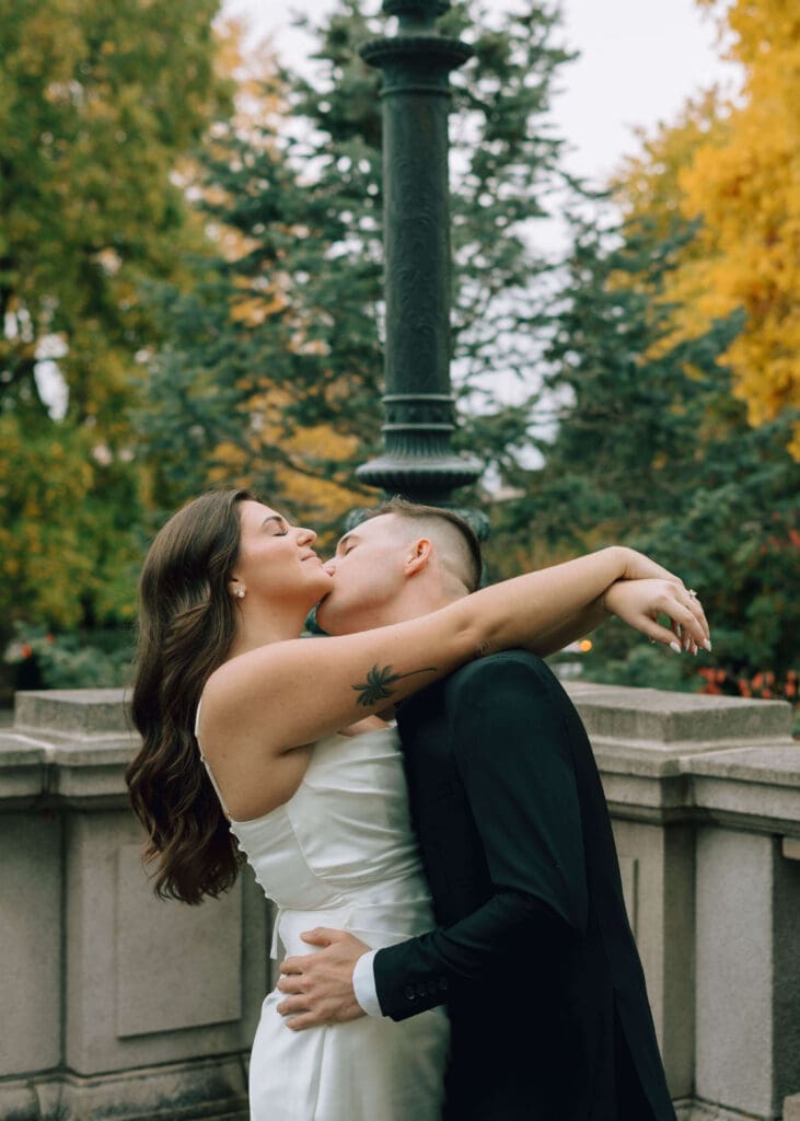 groom kissing bride on the cheek outside olympia