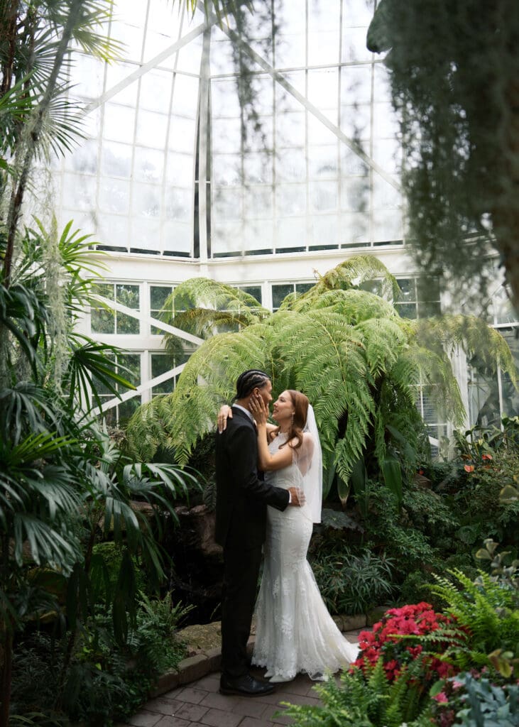bride and groom looking at each other at greenhouse wedding venue in Tacoma 