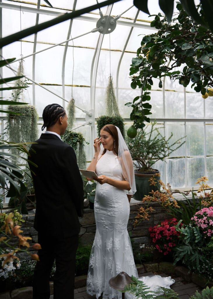 private vows and bride crying at W.W. Seymour Botanical Conservatory wedding 