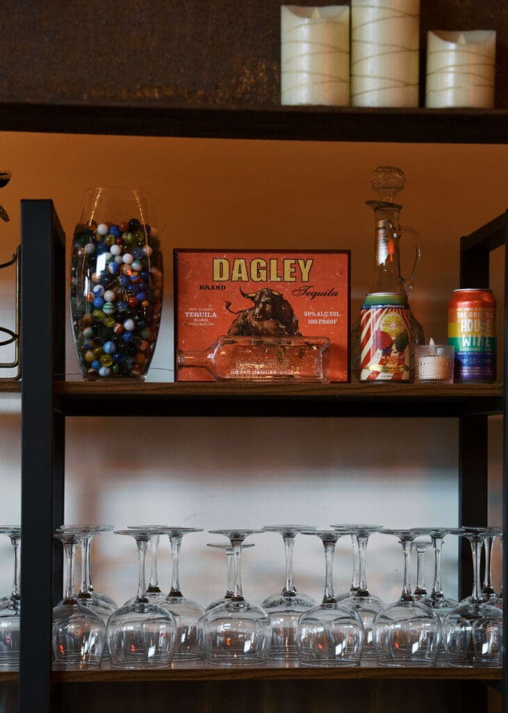 glasses on a bar shelf with decor at Tacoma wedding venue