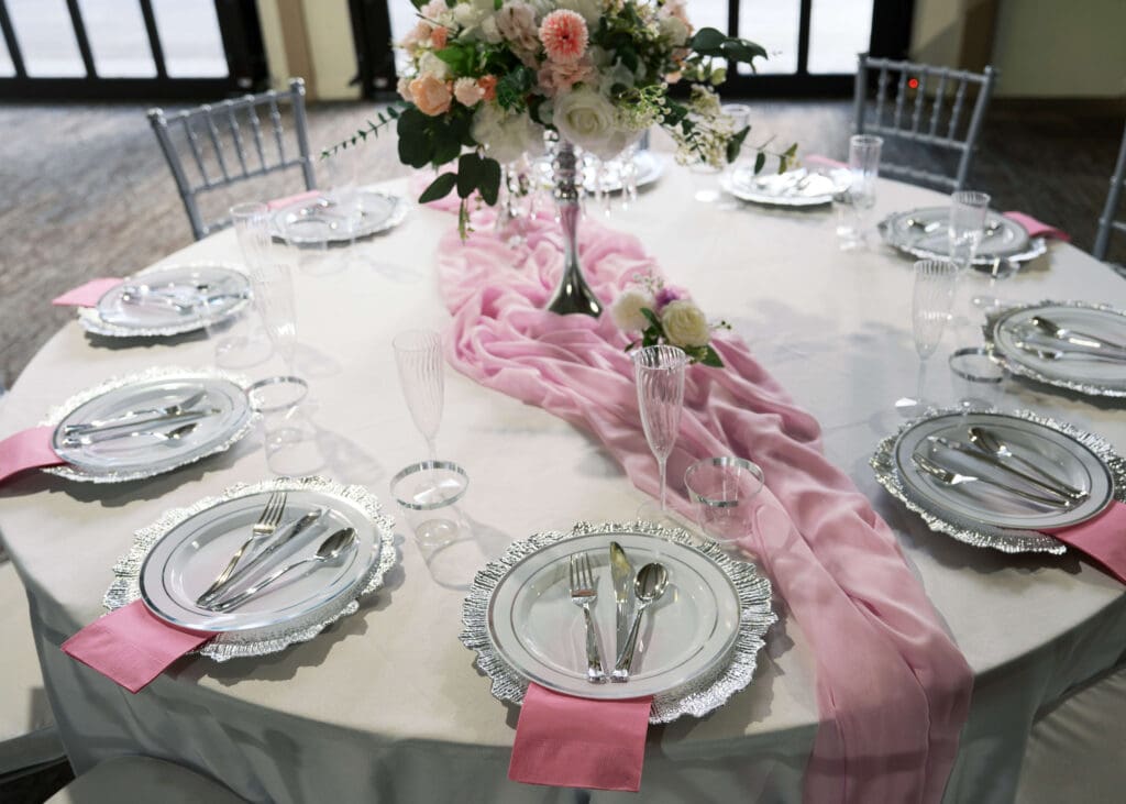 table set up with pink floral centerpiece 