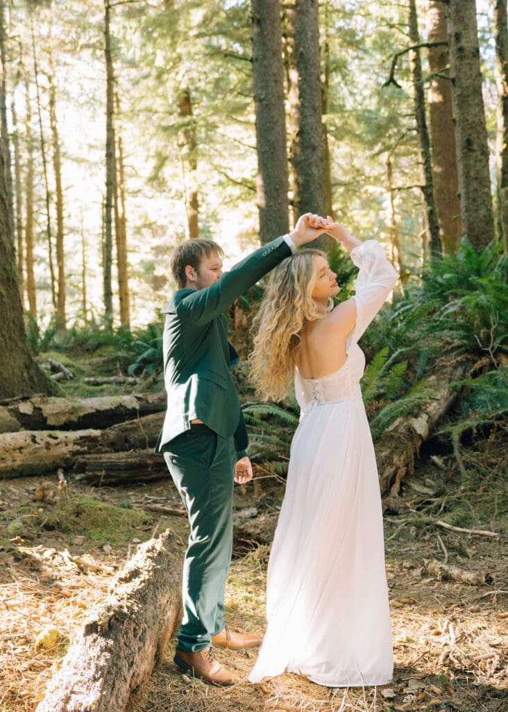 man spinning partner in the forest in Oregon by Ecola state park elopement photographer 