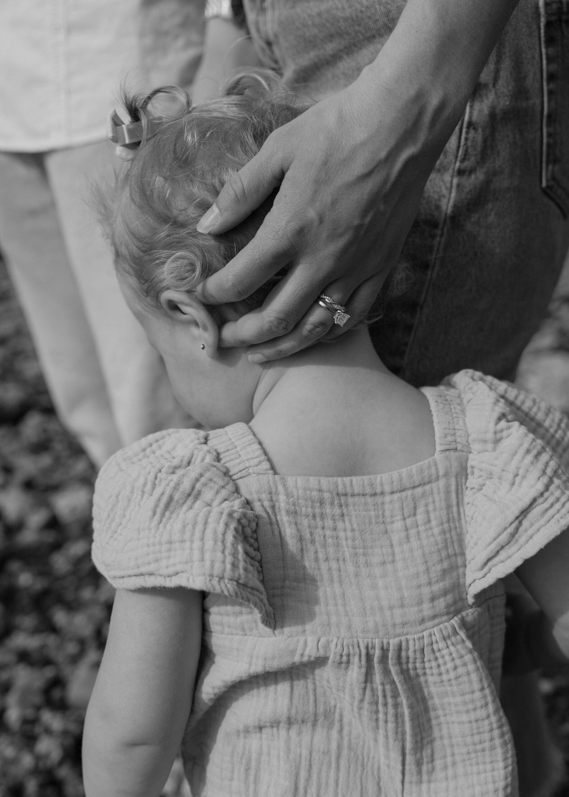 mother holding the back of her toddlers head on a beach in Washington