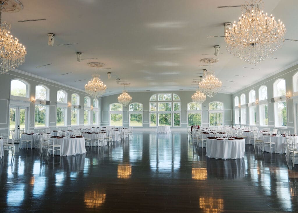 ballroom with big windows and chandeliers at Black horse manor