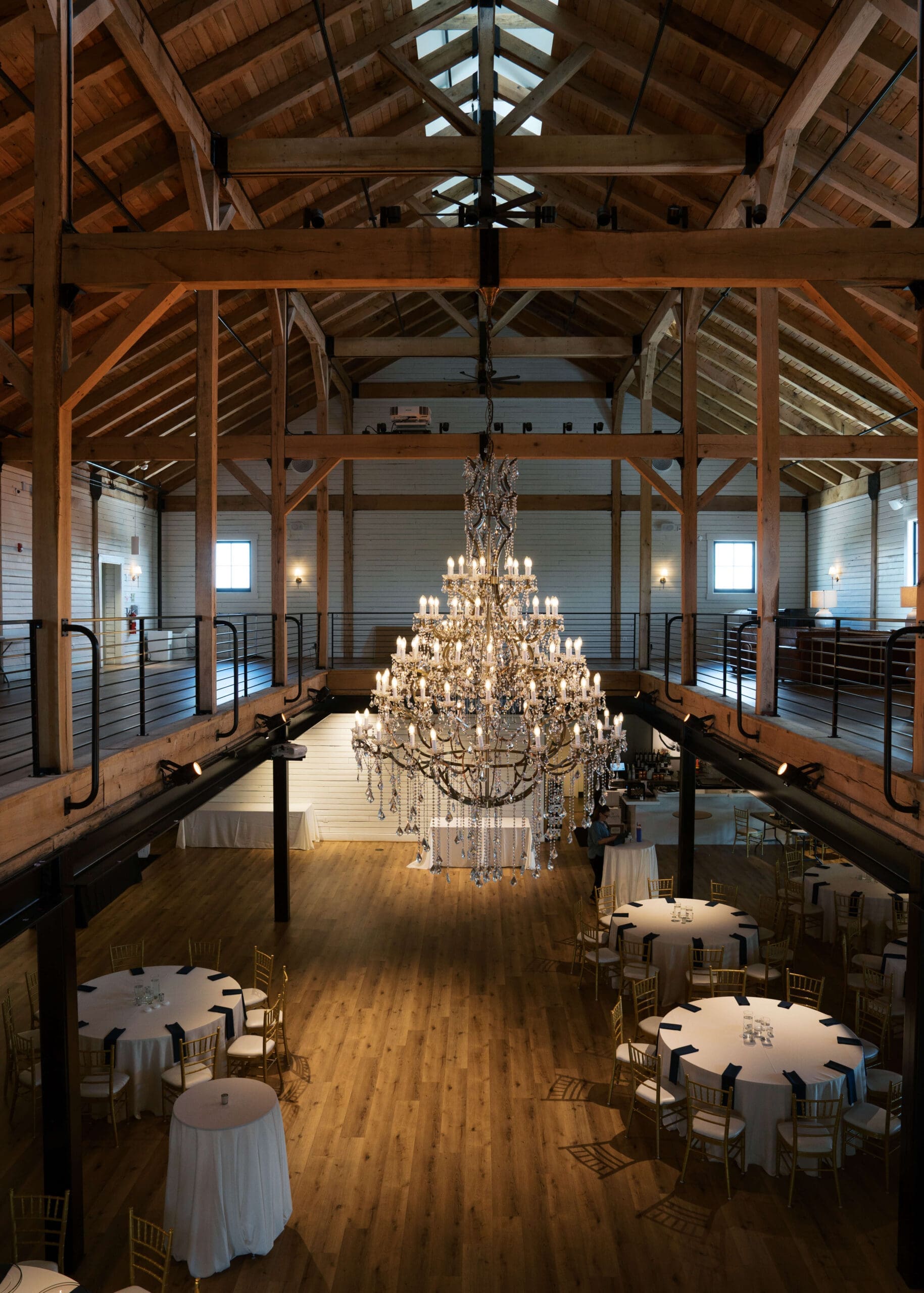 chandelier in dark lit moden ballroom at brentsville hall