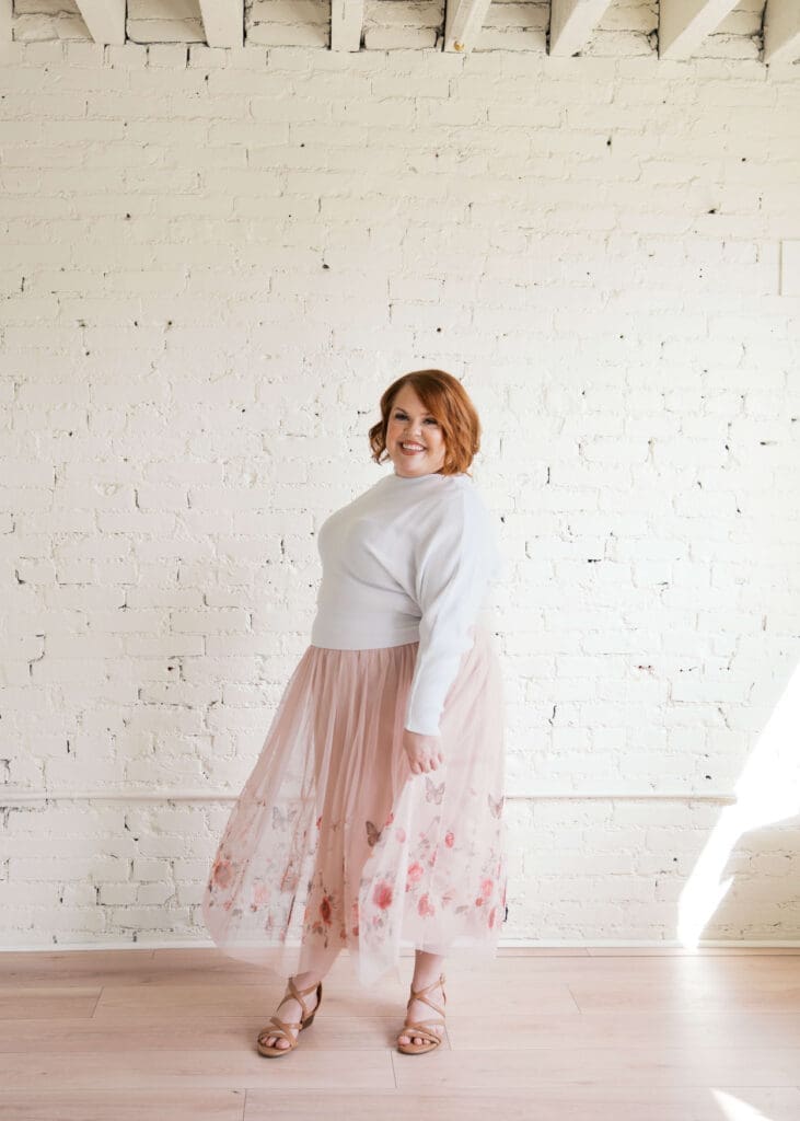 red head wedding planner with Elegant Affairs twirling her pink skirt
