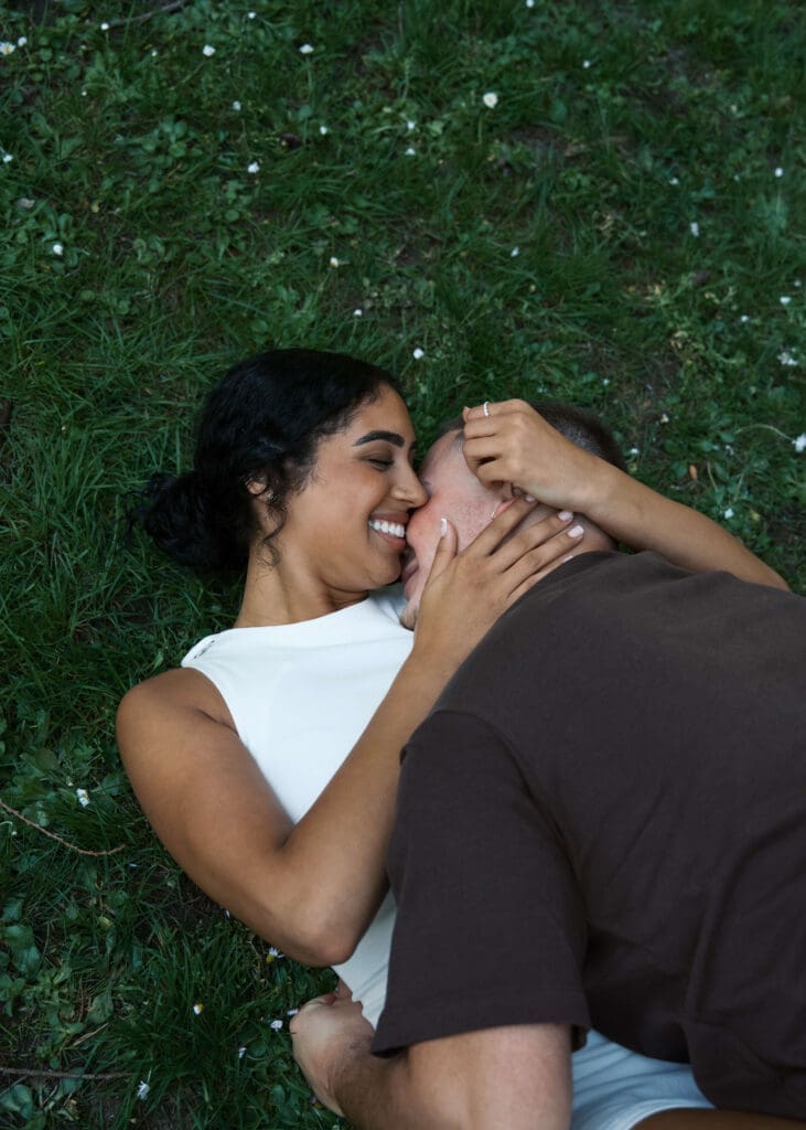 couple rolling in the grass in a Seattle park