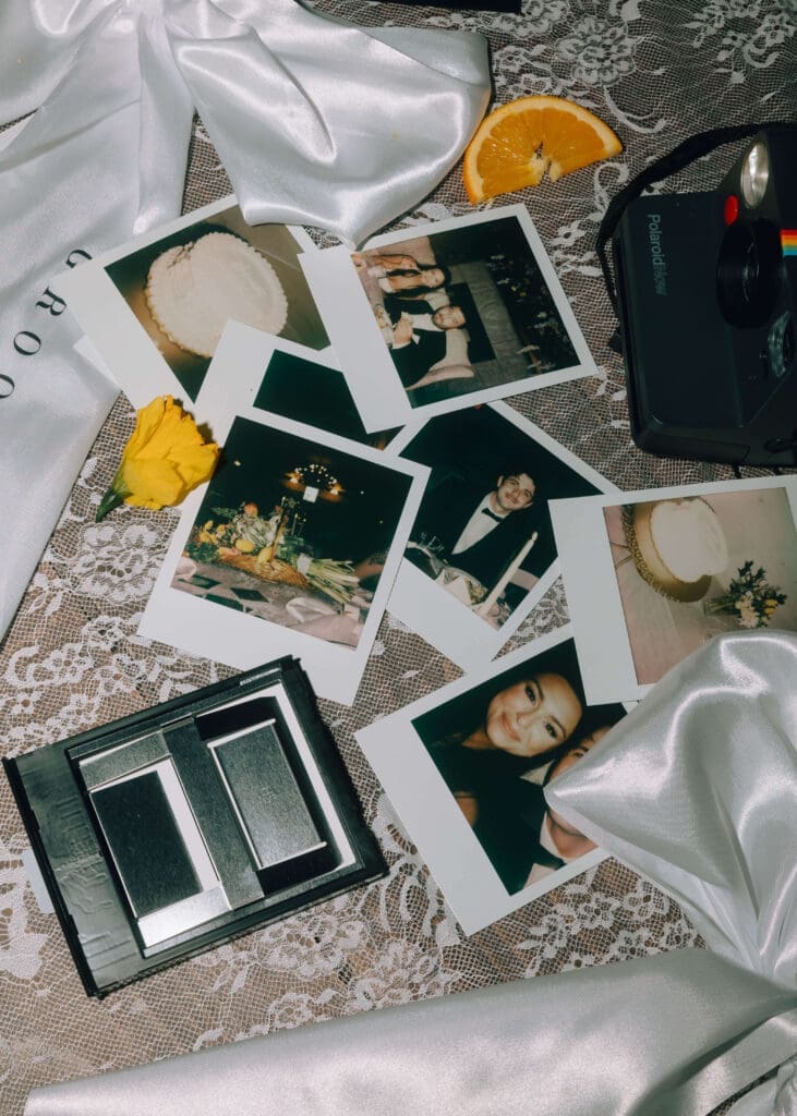 polaroid pictures, bows and oranges on table at Silver Cloud Hotel