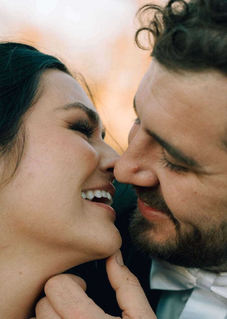 couple touching noses and smiling at each other at Bibb Mill event center
