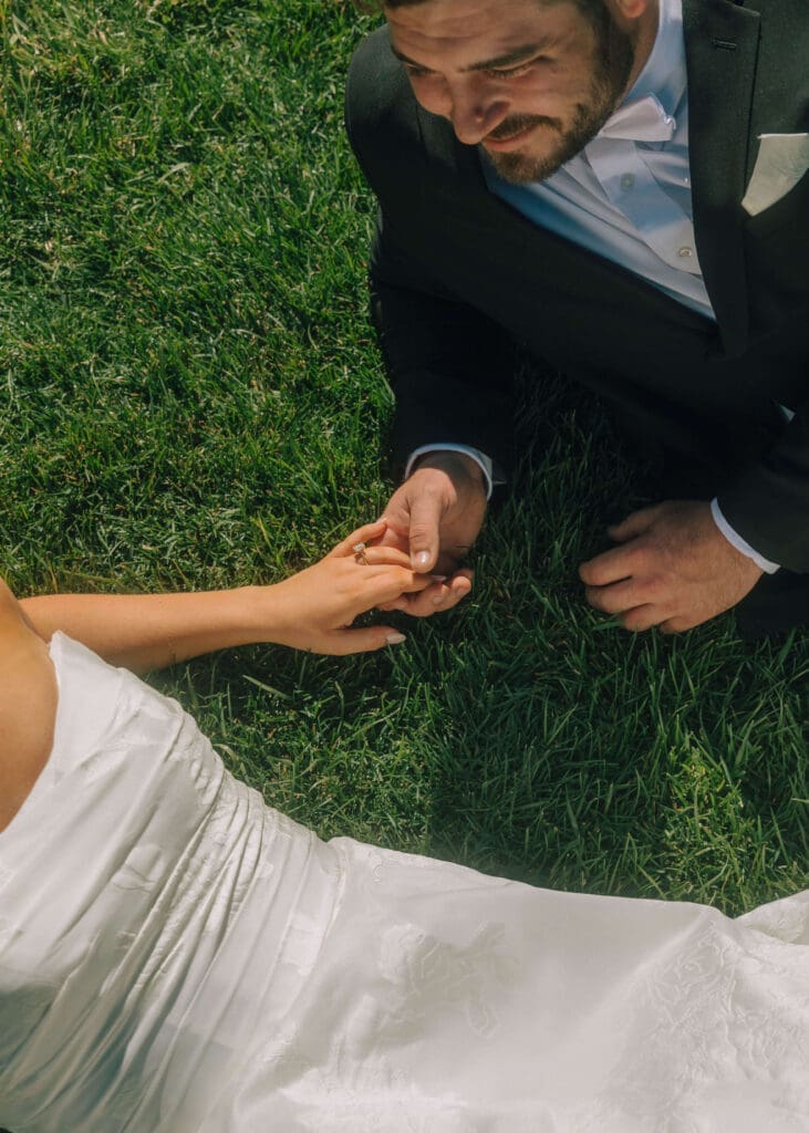 couple holding hands in the grass on their wedding day in Columbus, GA