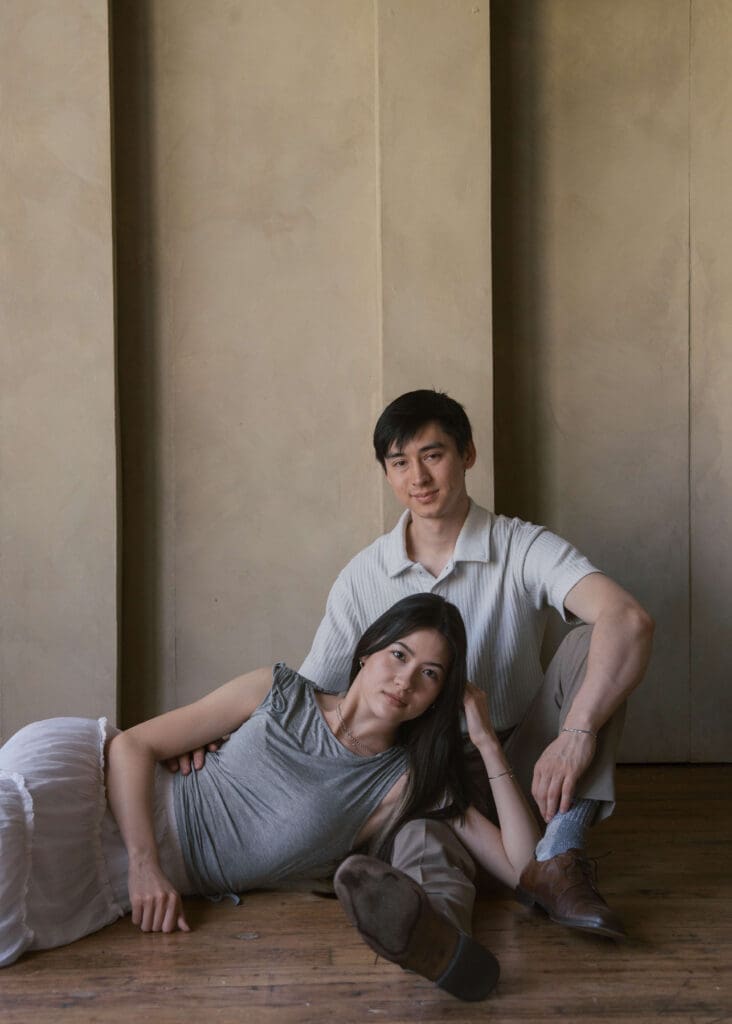 woman laying down across partner's lap with her head on her hand 