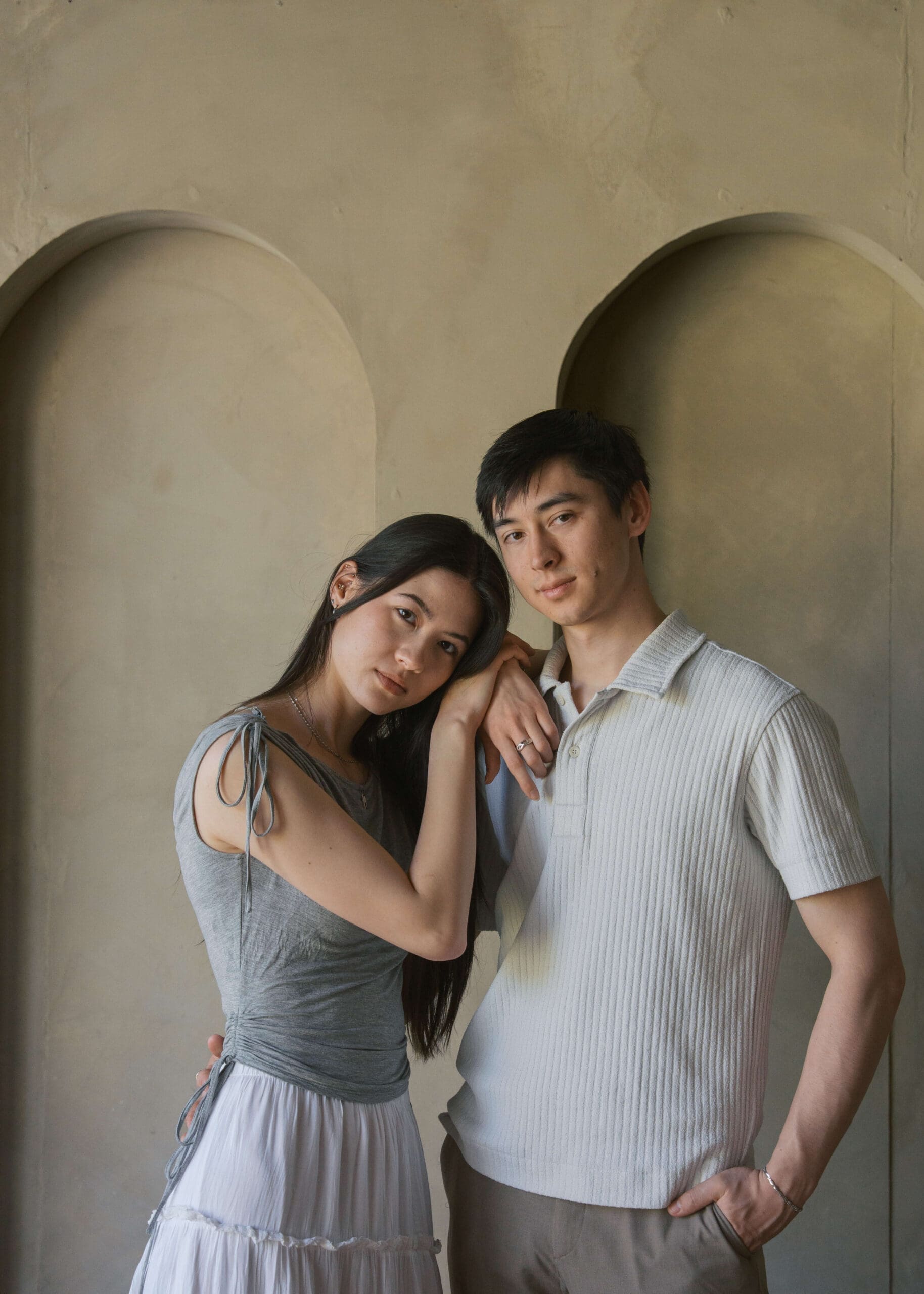 couple in a photo studio and woman is leaning on partner's shoulder at a Seattle photo studio