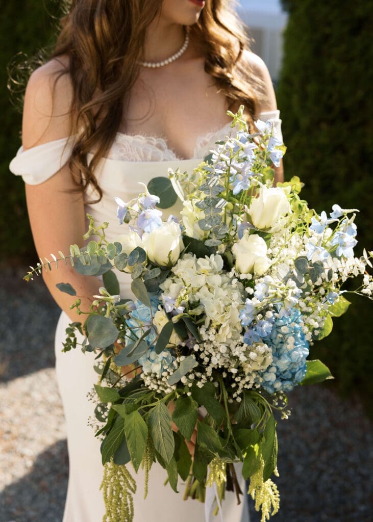 bride holding blue and white bouquet at summer wedding in Georgia