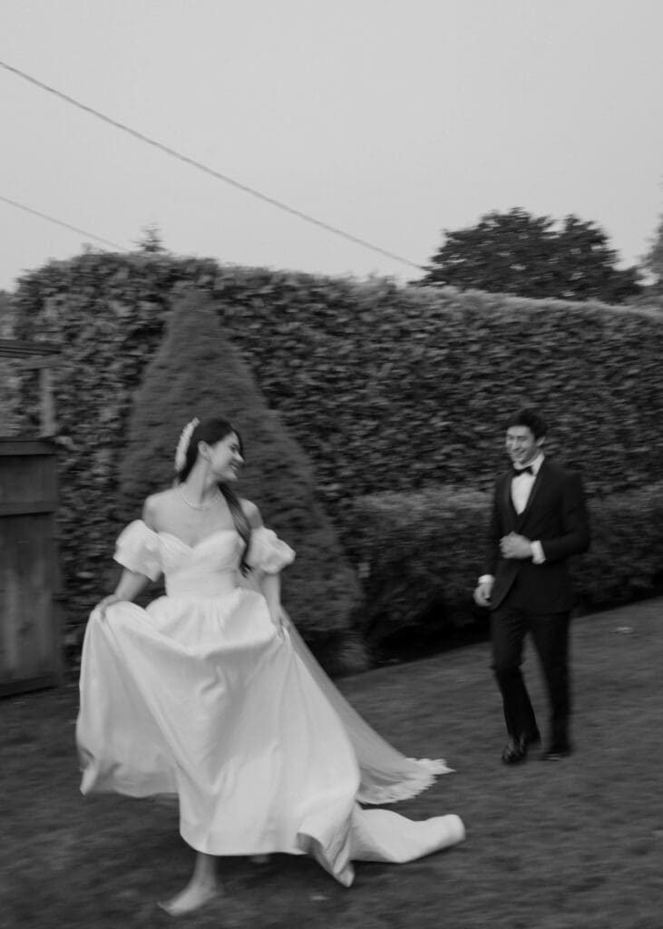 groom chasing his bride through the garden at Orting Manor