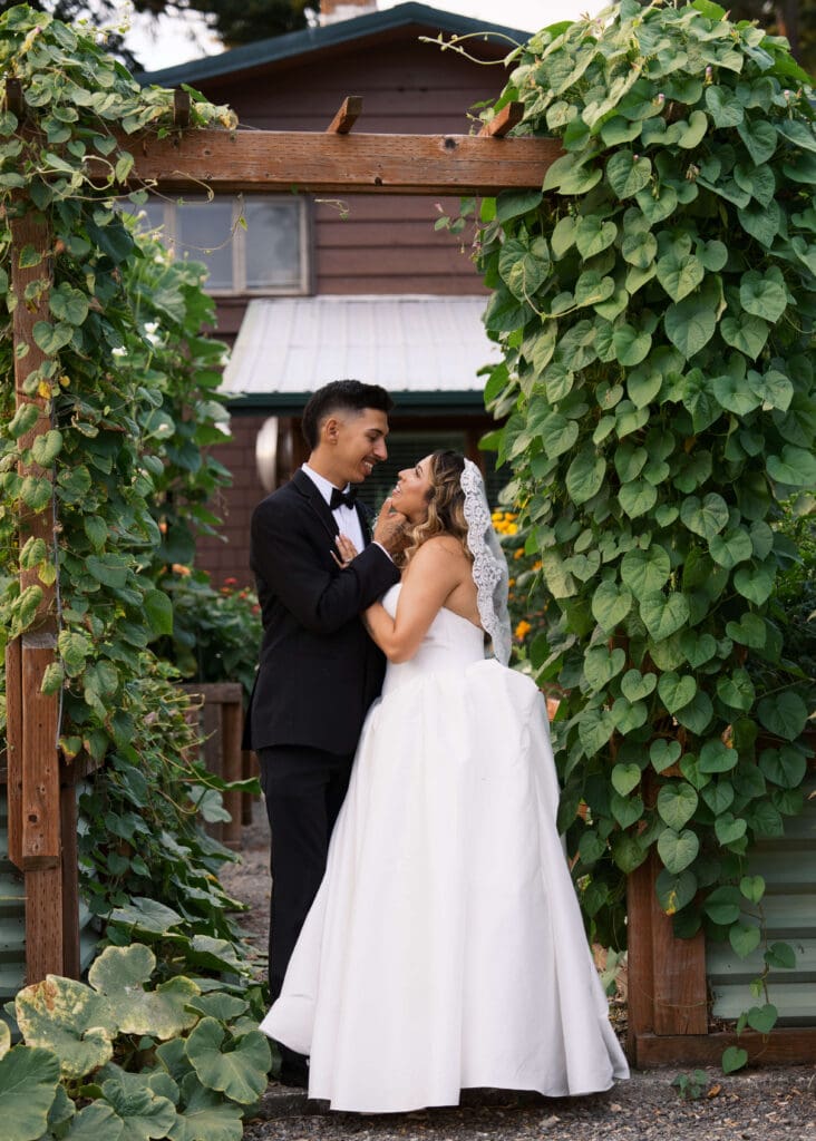 couple standing under an arch at Rock creek gardens on their wedding day