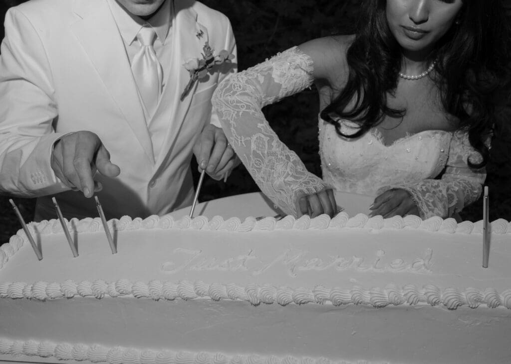 couple putting candles in their wedding cake at Atelier Tacoma