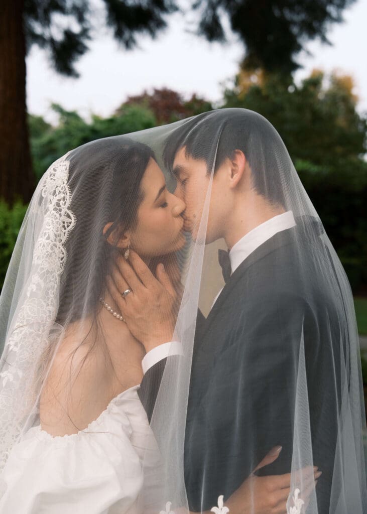 bride and groom kissing under the veil at Black Horse Manor